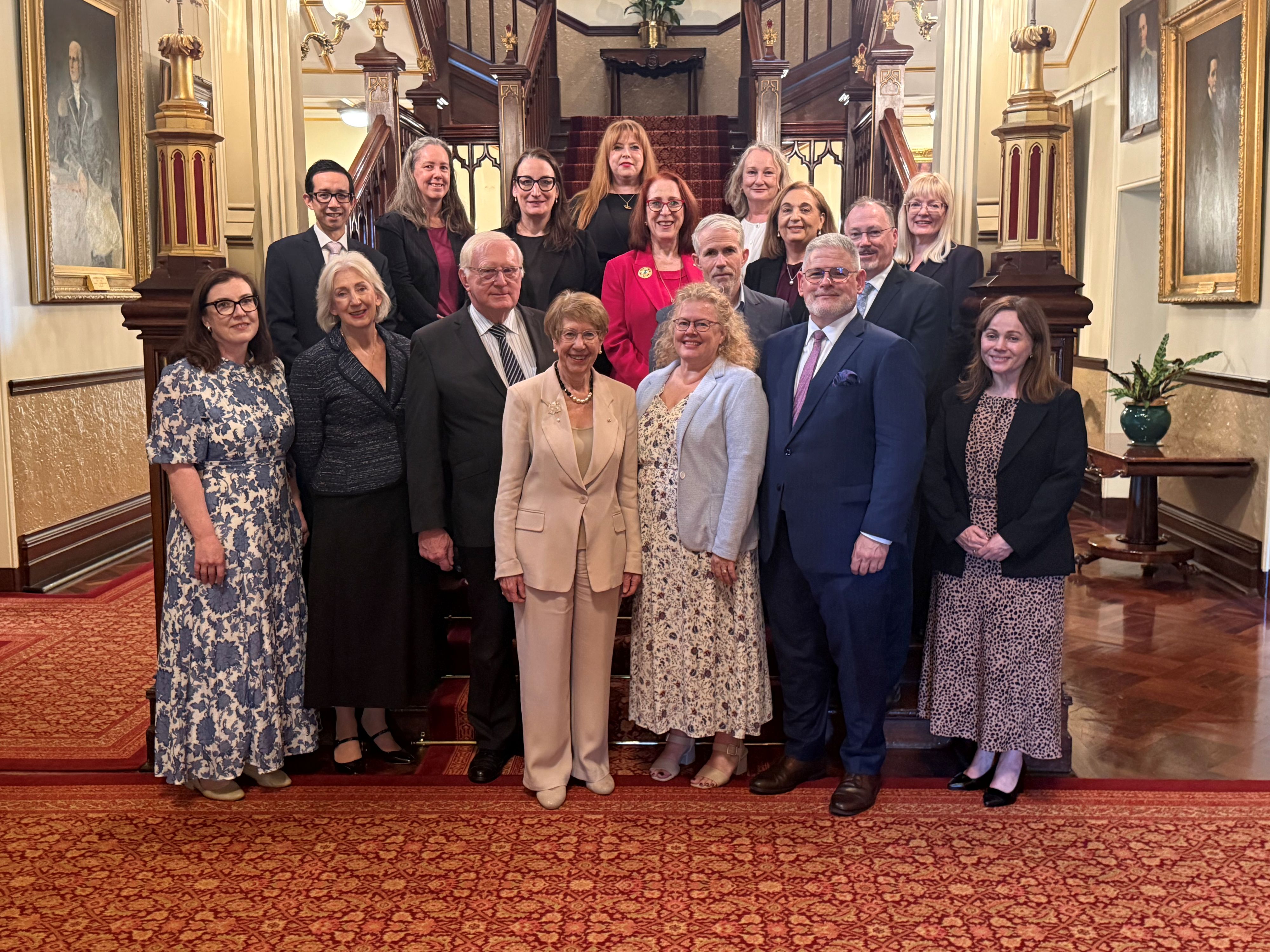 Group photo of the Hon Margaret Beazley AC KC with AIAC Members indoors at Government House